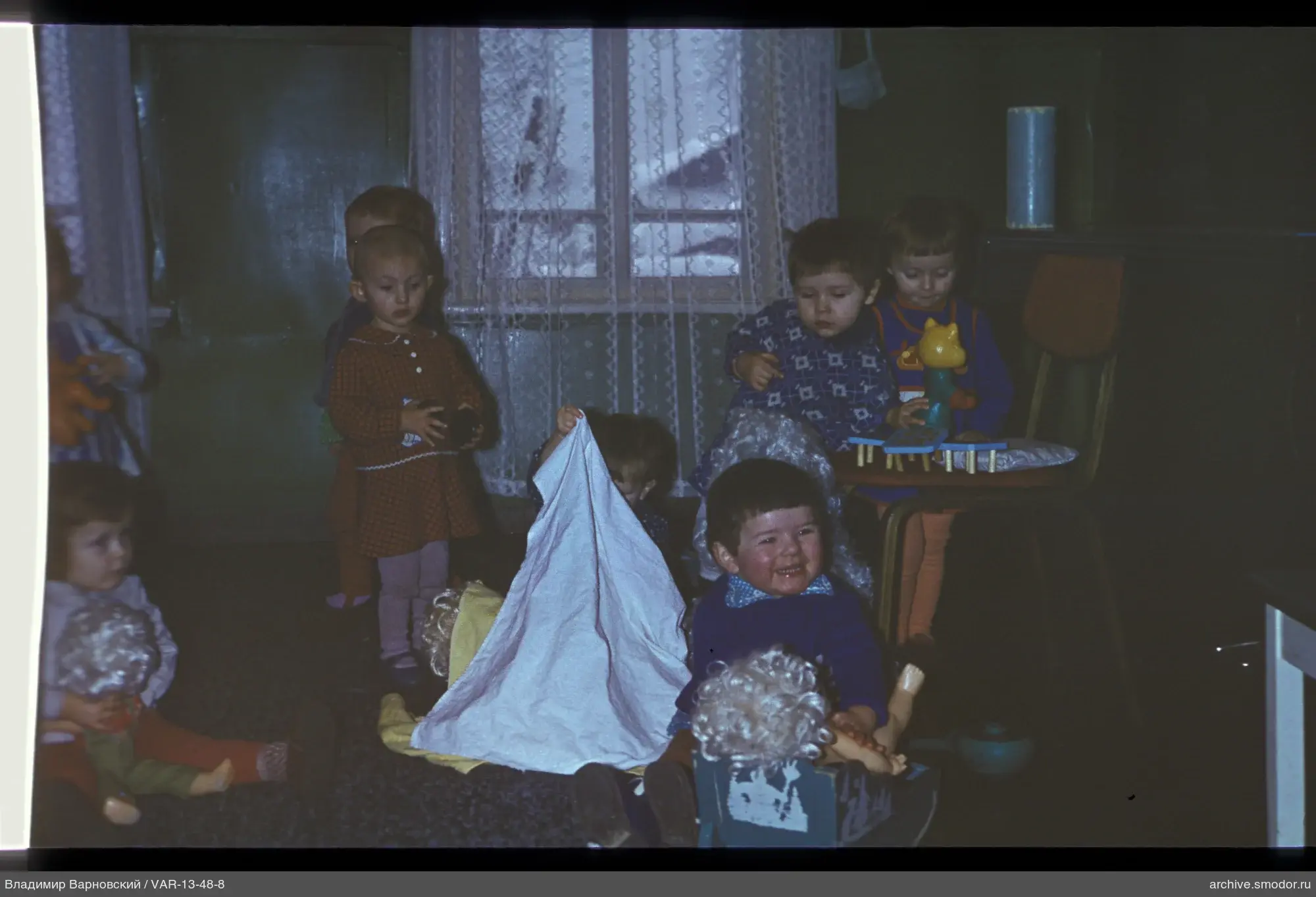 Group of children in a room with green walls