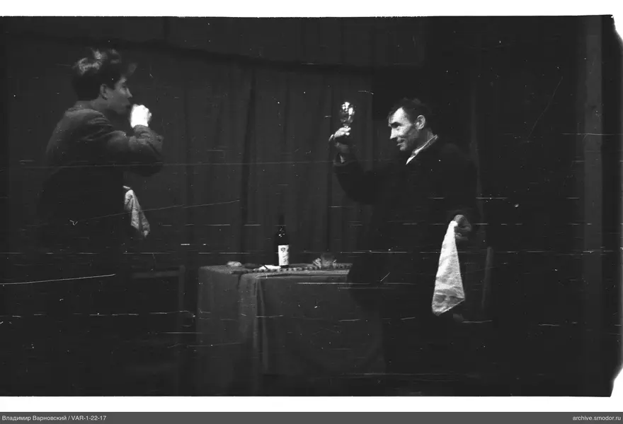 Two men at a table during an event
