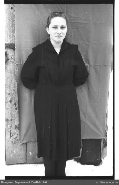 Portrait of a woman in a dark dress on snow