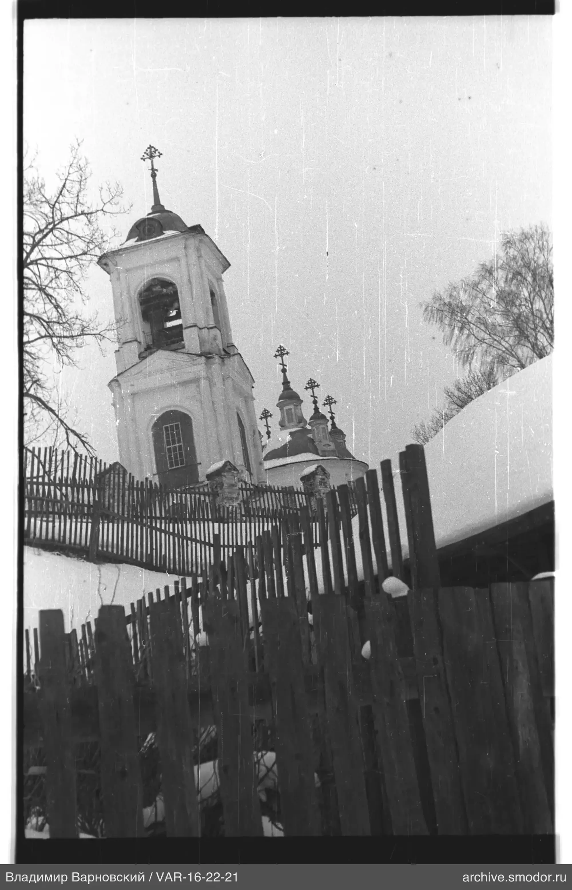 Church bell tower and snow-covered landscape