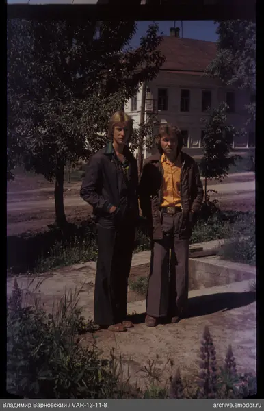 Two men standing on the sidewalk