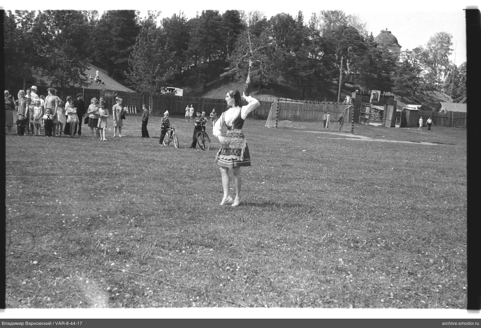 Girl in traditional costume on field