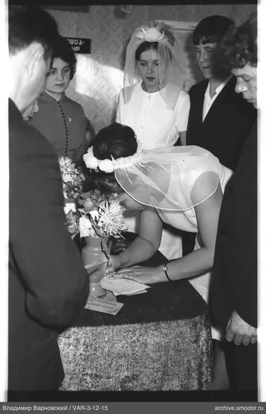 Woman signing a document at an event