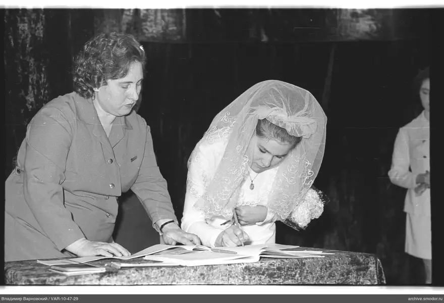 Woman signing a document at the event