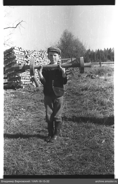 Junge mit Holzgerät auf den Schultern