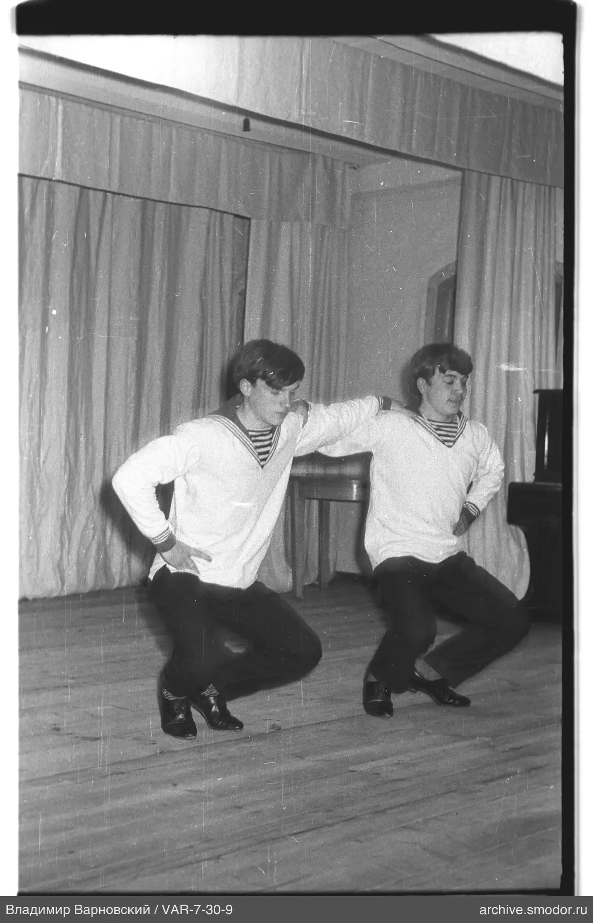 Two young men in matching shirts