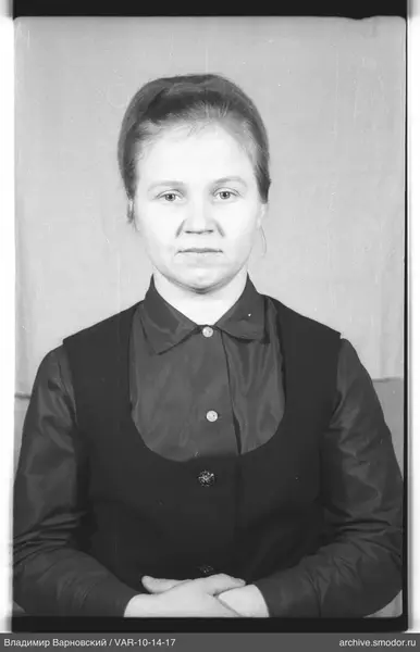 Portrait of a woman in a dark shirt and vest