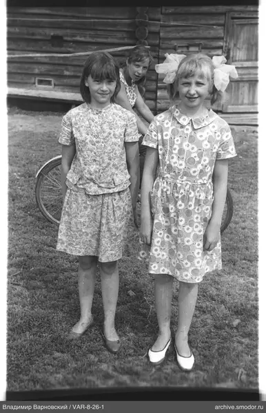 Group portrait of three girls on grass