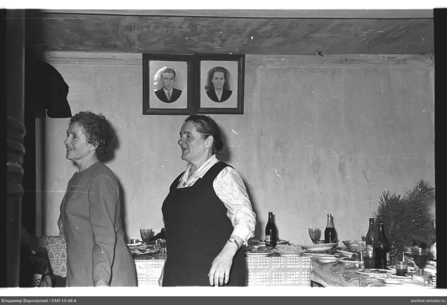 Two women with tableware and portraits