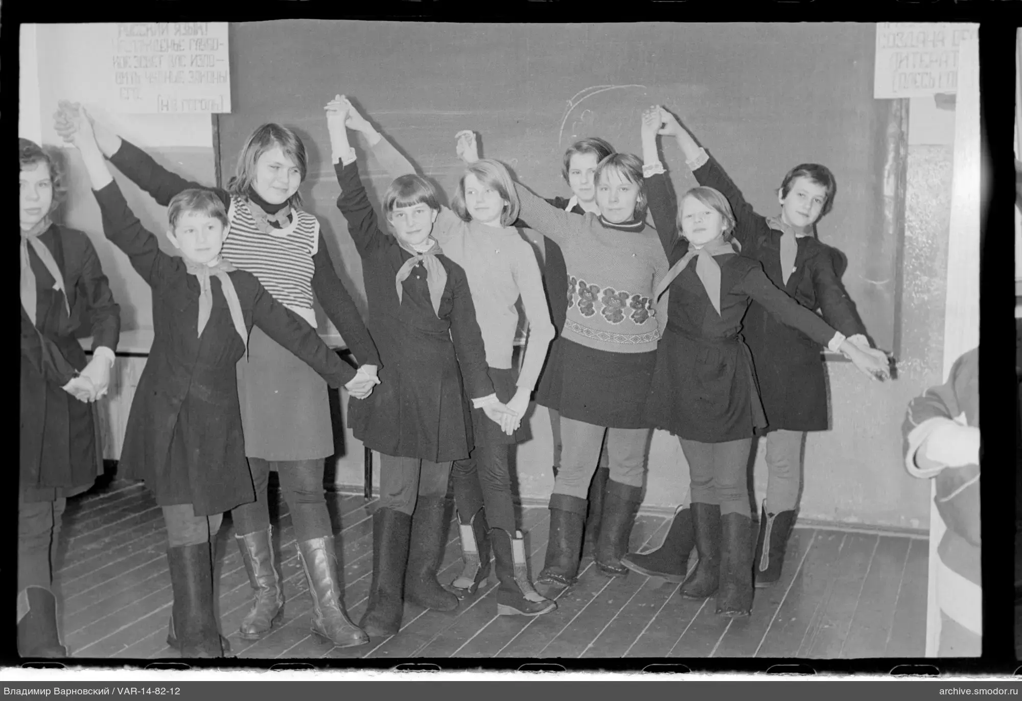 Group portrait of girls and woman in school setting