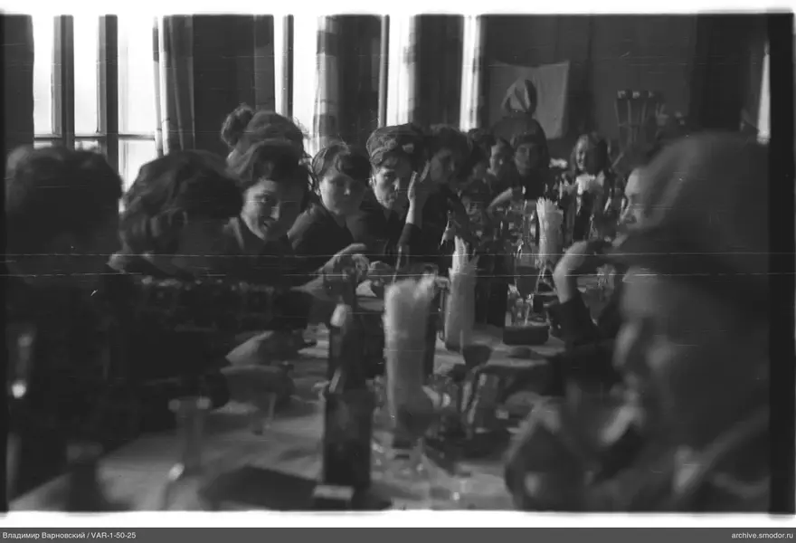 People sitting at a long table at an event