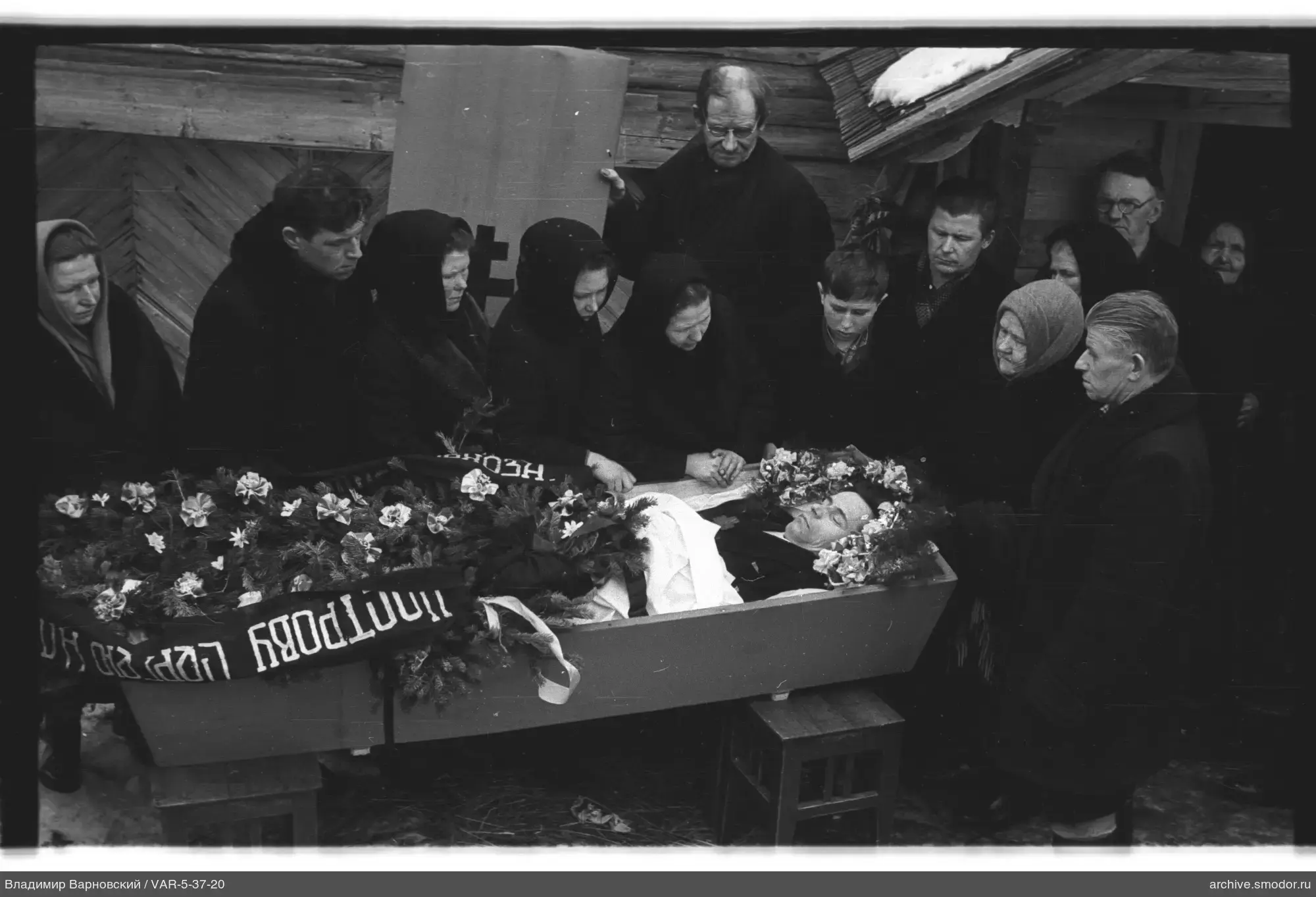 Group around a coffin at a funeral