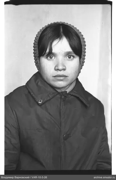 Portrait of a woman in a dark jacket and knitted hat