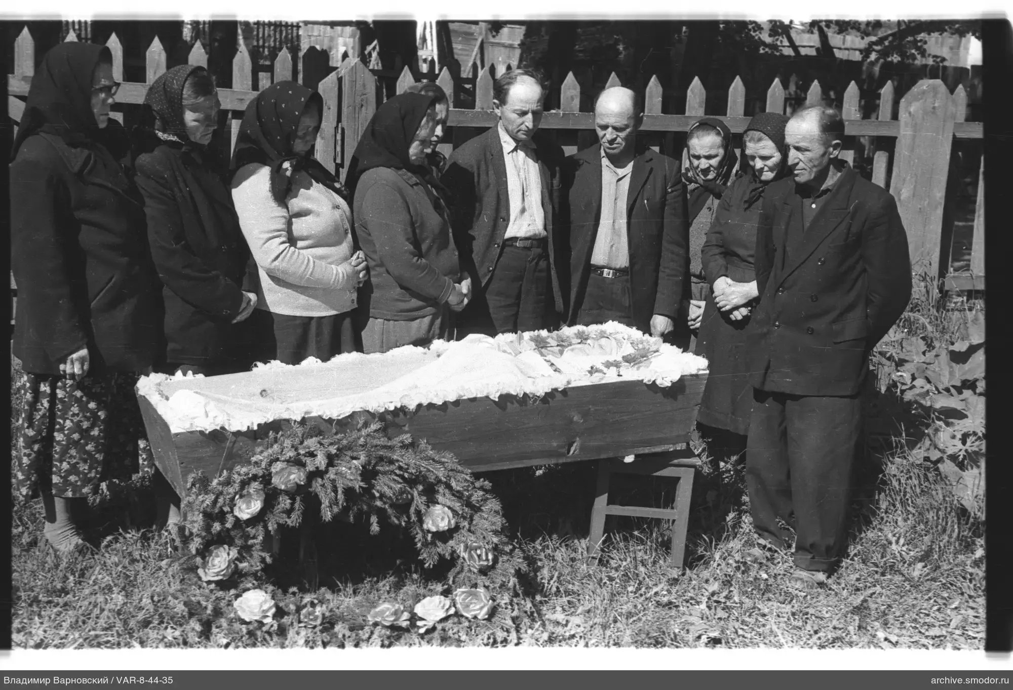 Group around a wooden coffin