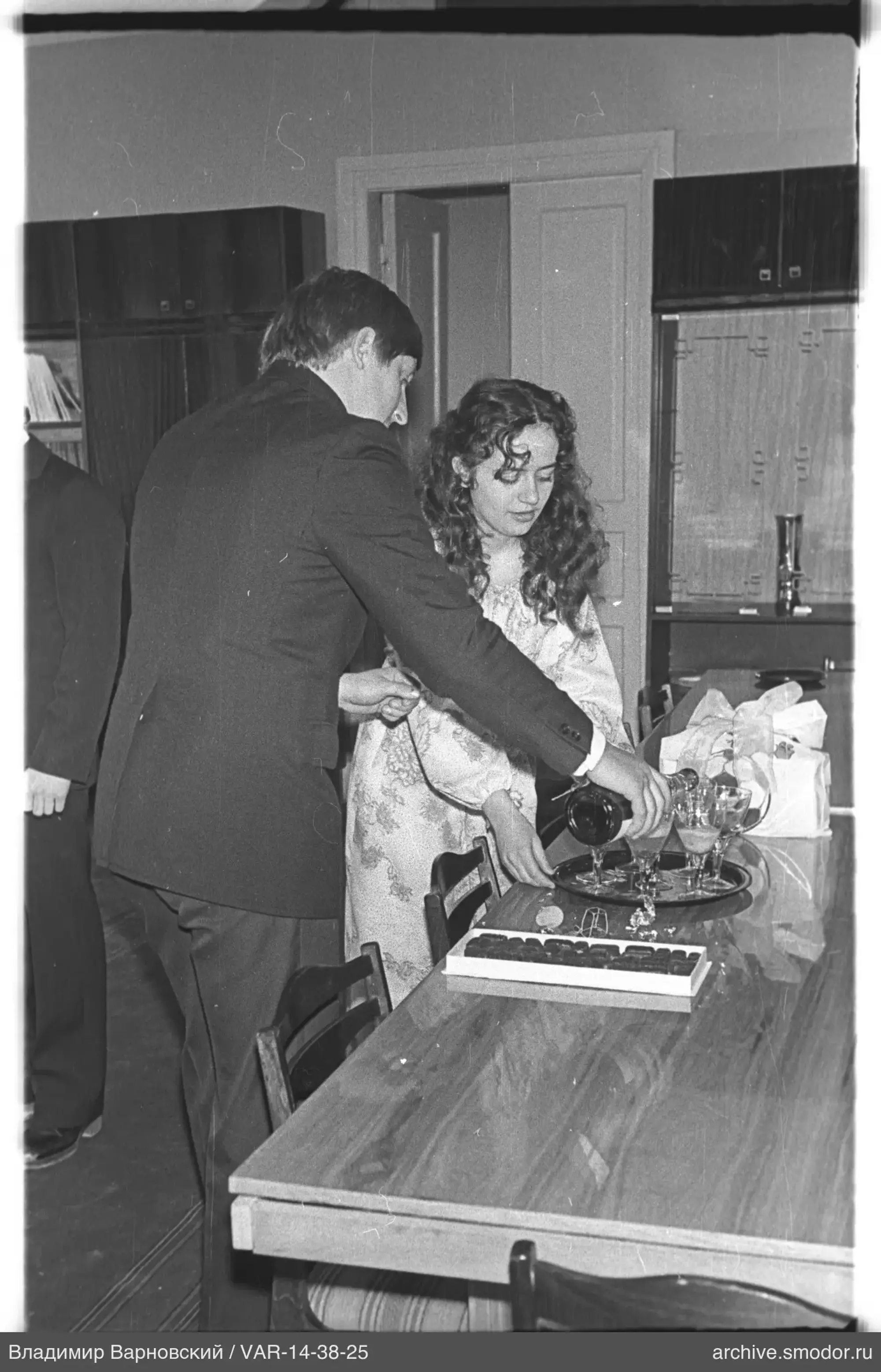 Man pouring drink to woman