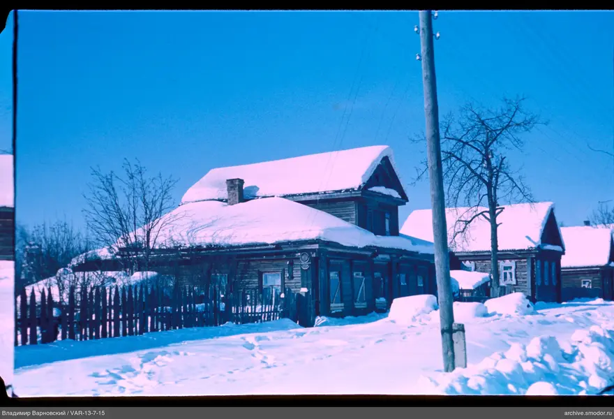 Wooden houses with fence and snow