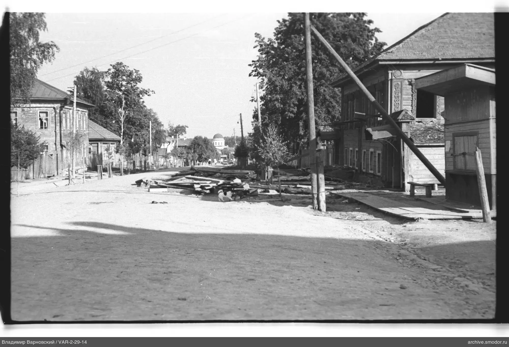Sandy street with wooden houses and church