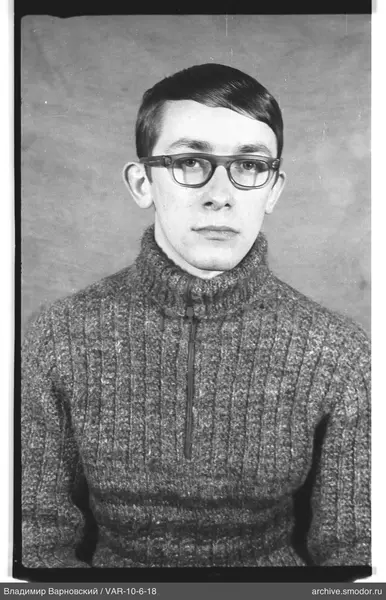Portrait of a man in a sweater and glasses