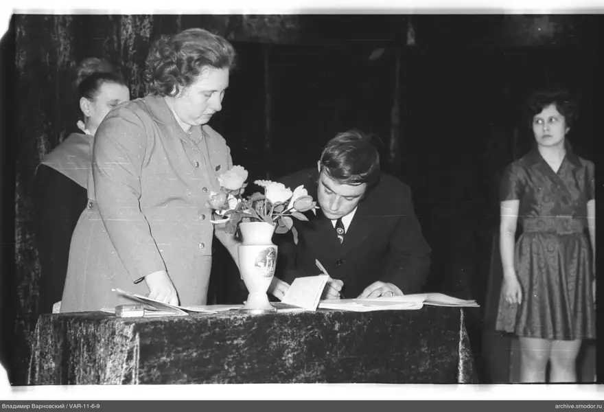 Man writing at a table during an event