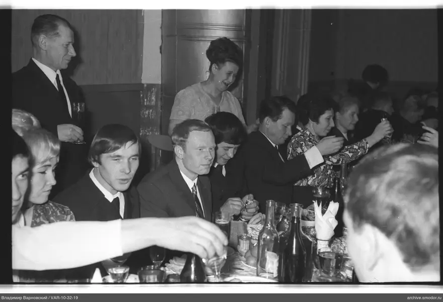 People sitting at a long table during an event