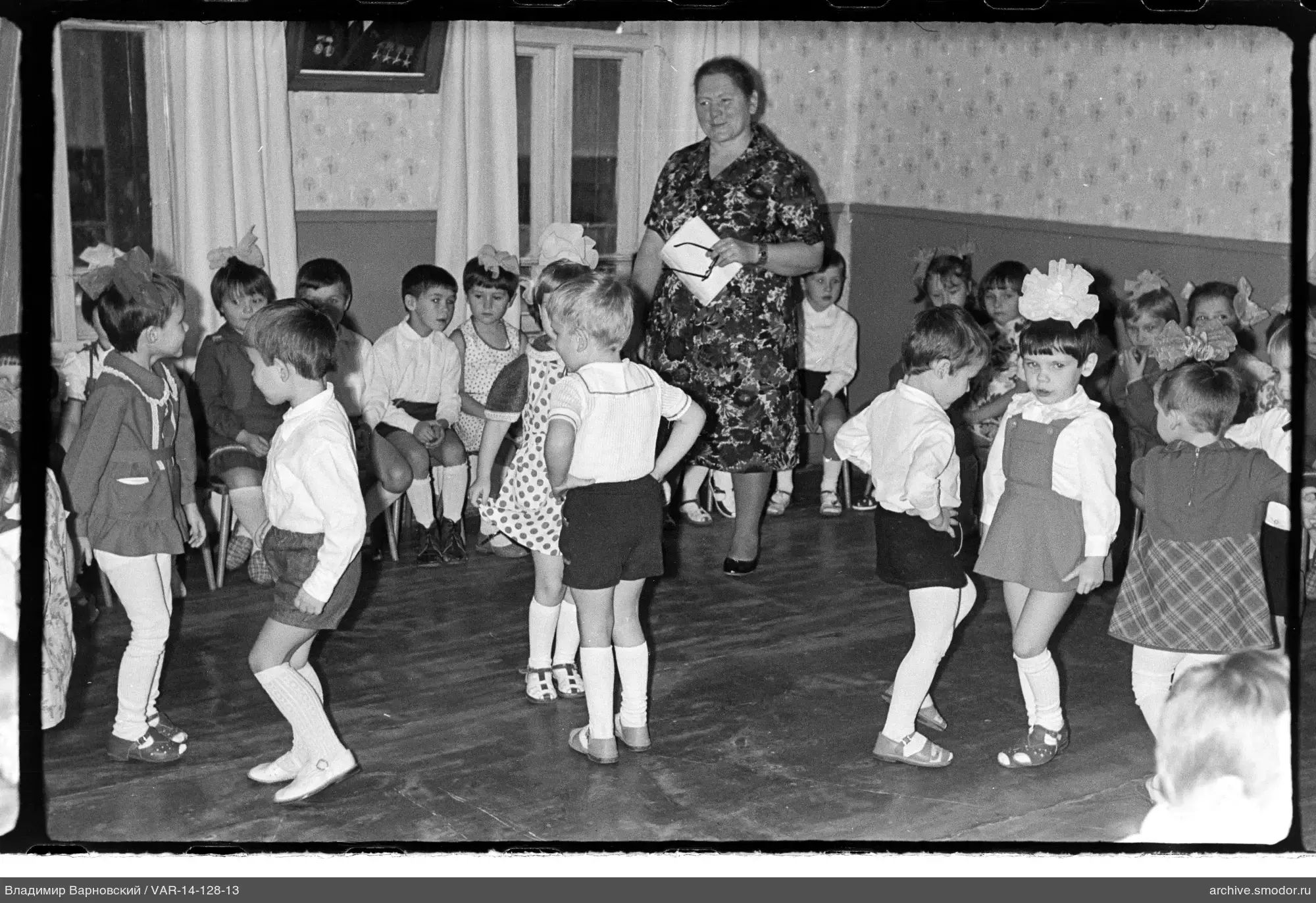 Kinder und Frau in einem Raum mit Tapeten