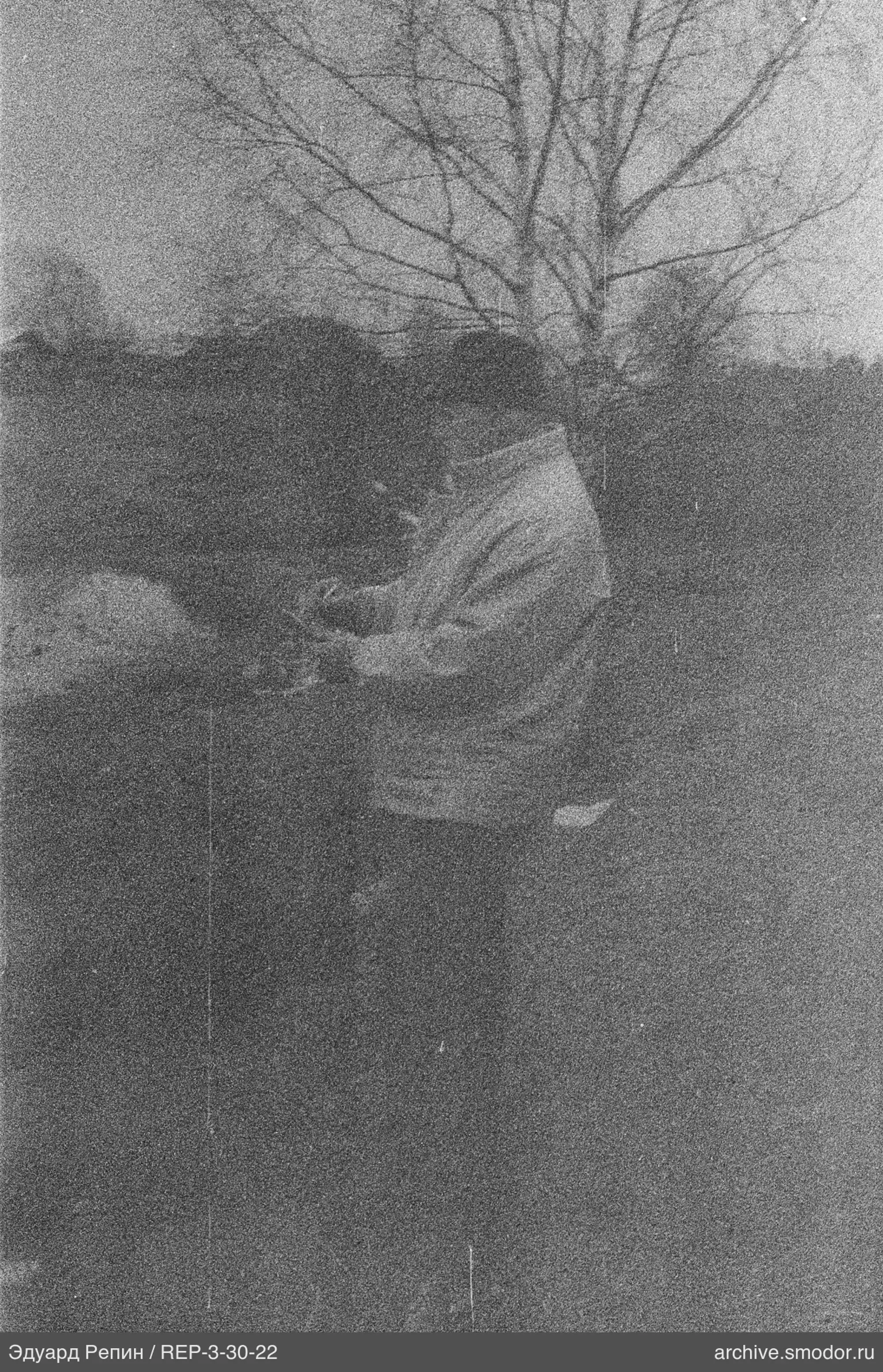 Man in light sweater and dark trousers