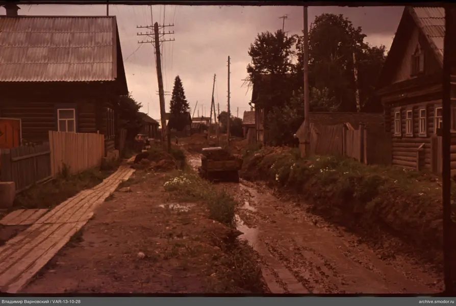 Dirt road between wooden houses