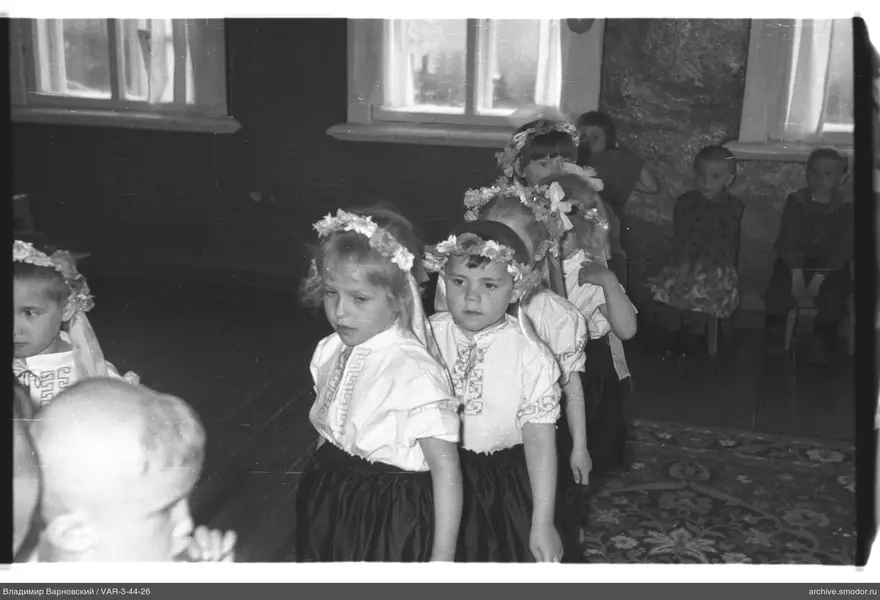 Kinder in Nationalkostümen und Alltagskleidung