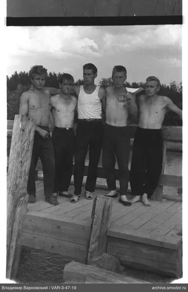 Group of men on a pier by water