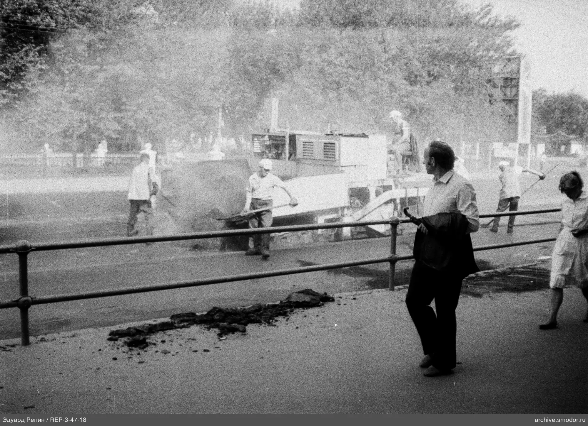 Workers laying asphalt on the road