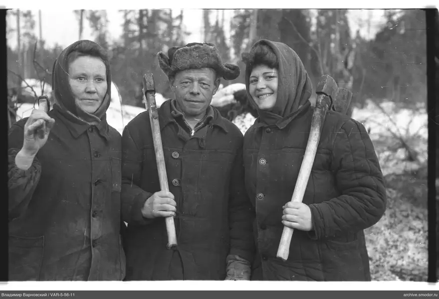 Group with axes against trees and snow