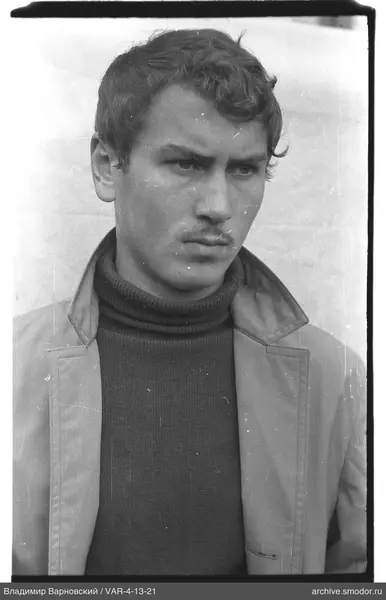 Portrait of a man in a light jacket and dark sweater