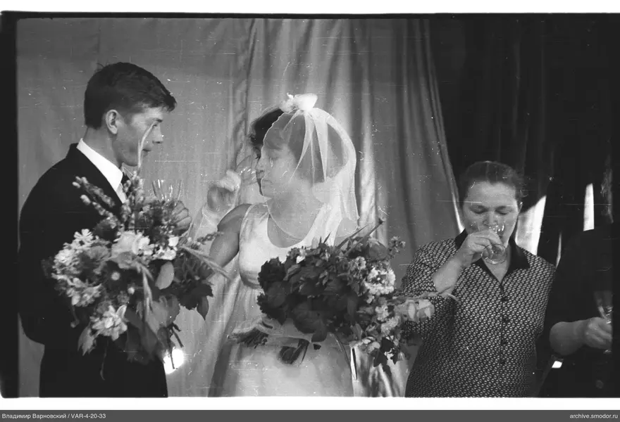 Man and women with bouquets and glasses