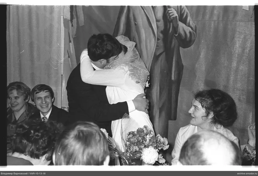 Embracing bride and groom at the event