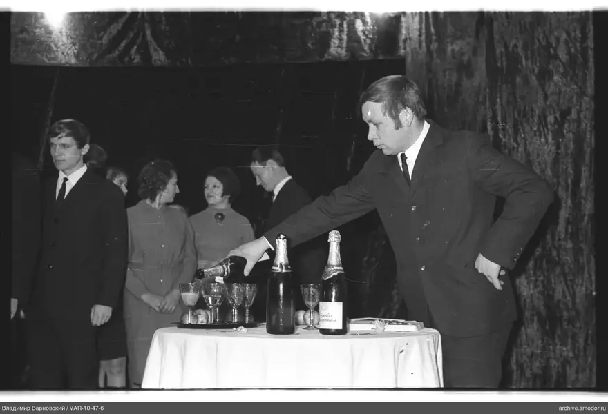Man pouring drink at event