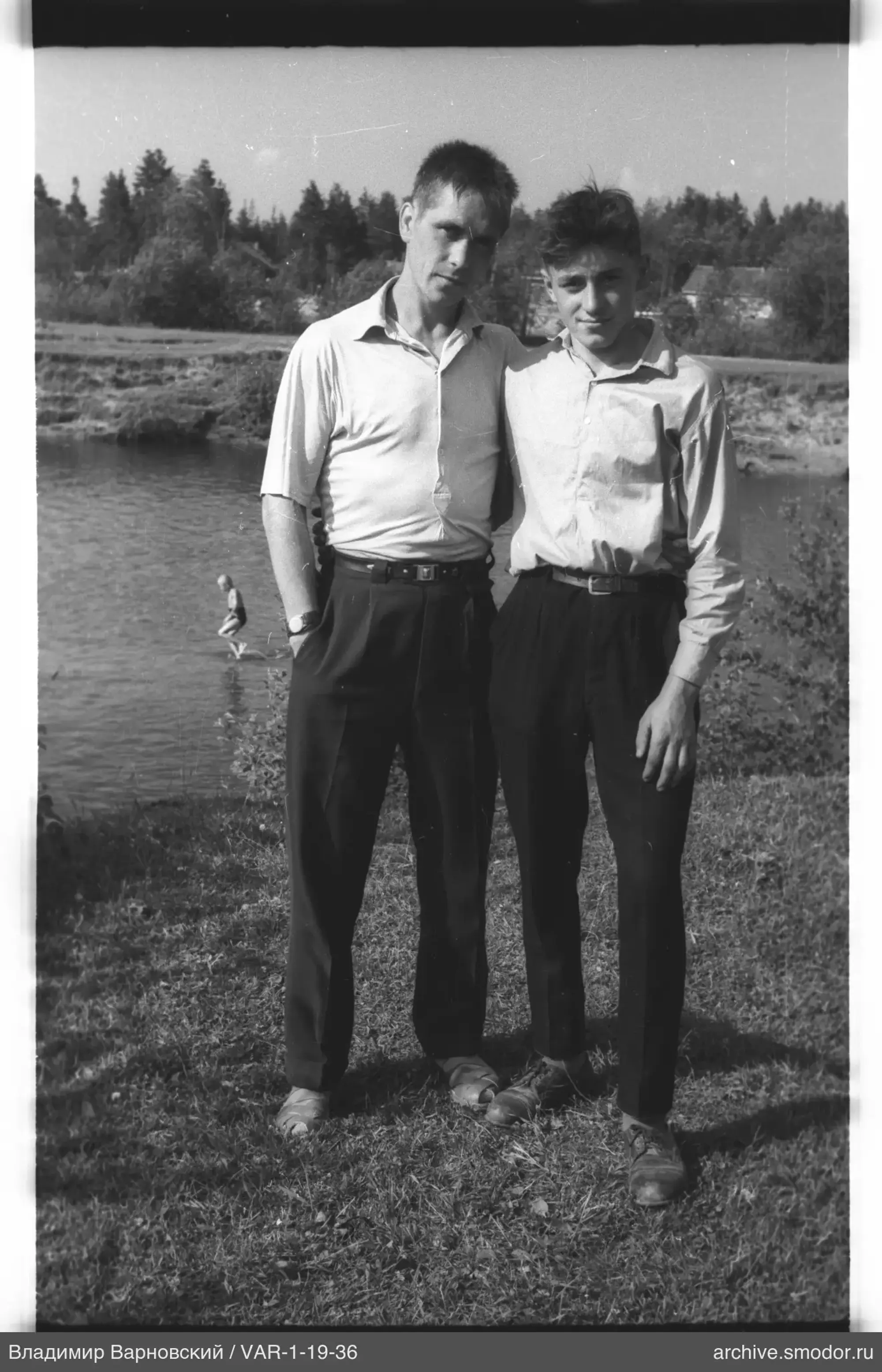 Two young men by the water