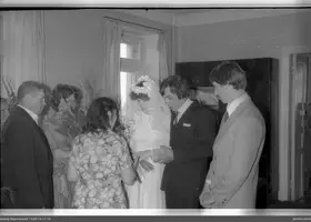 Group of people with document and wreath