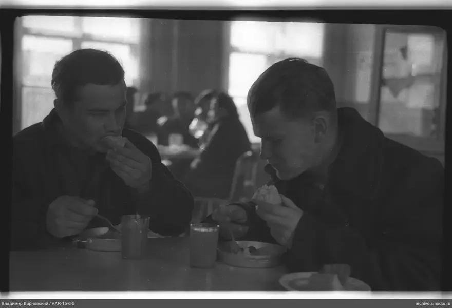 Two men eating at a table