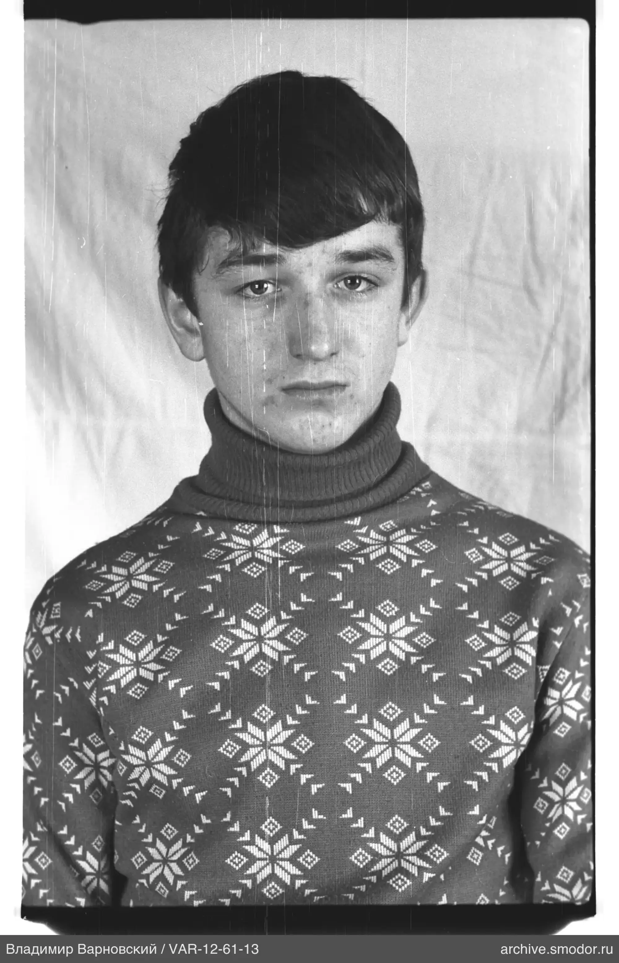 Portrait of a young man in a snowflake sweater