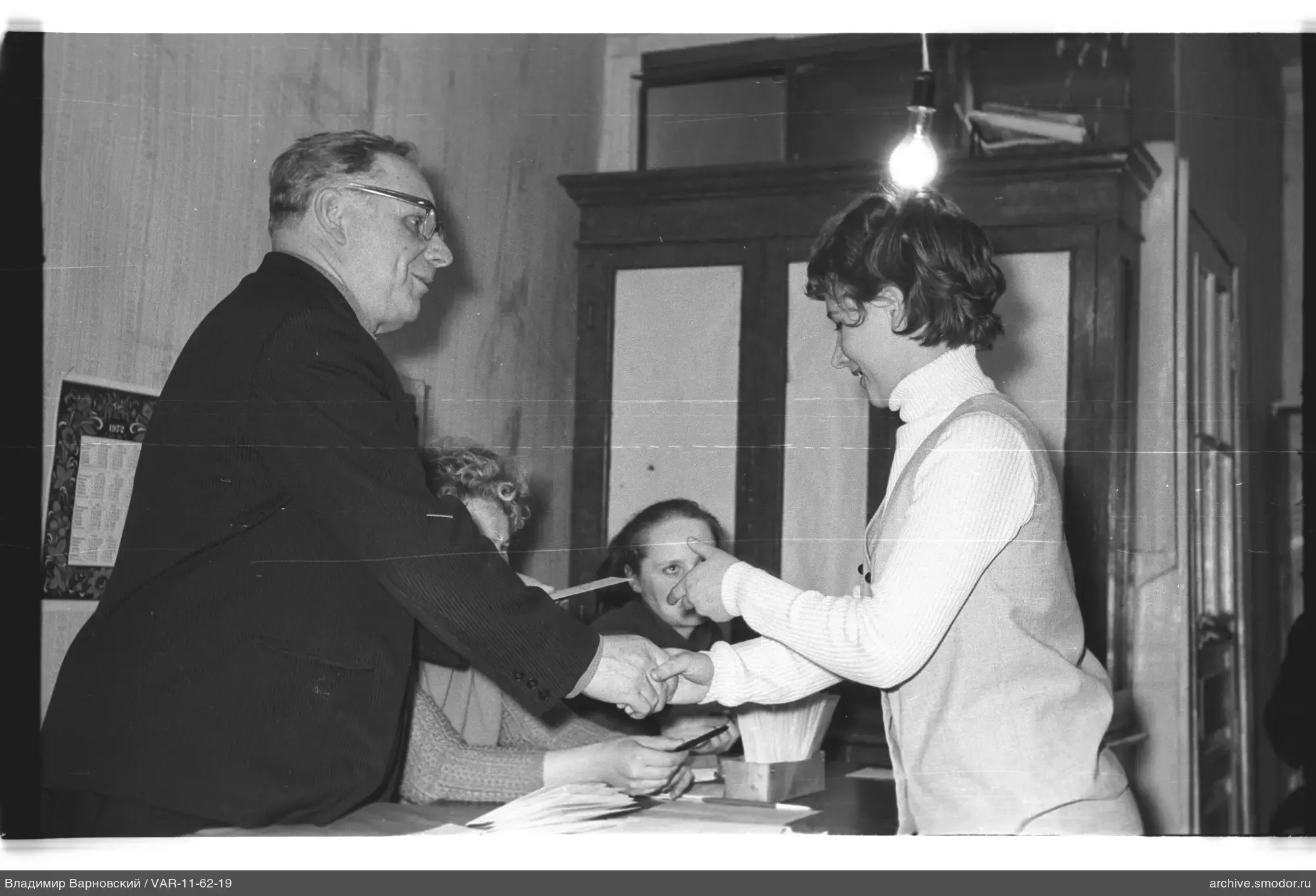 Man and woman shaking hands at event