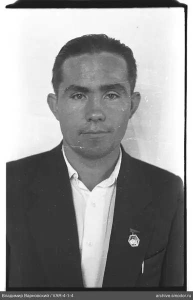 Portrait of a man in a jacket with a badge