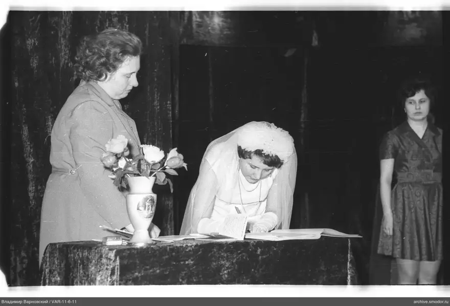 Bride signing a document at an event