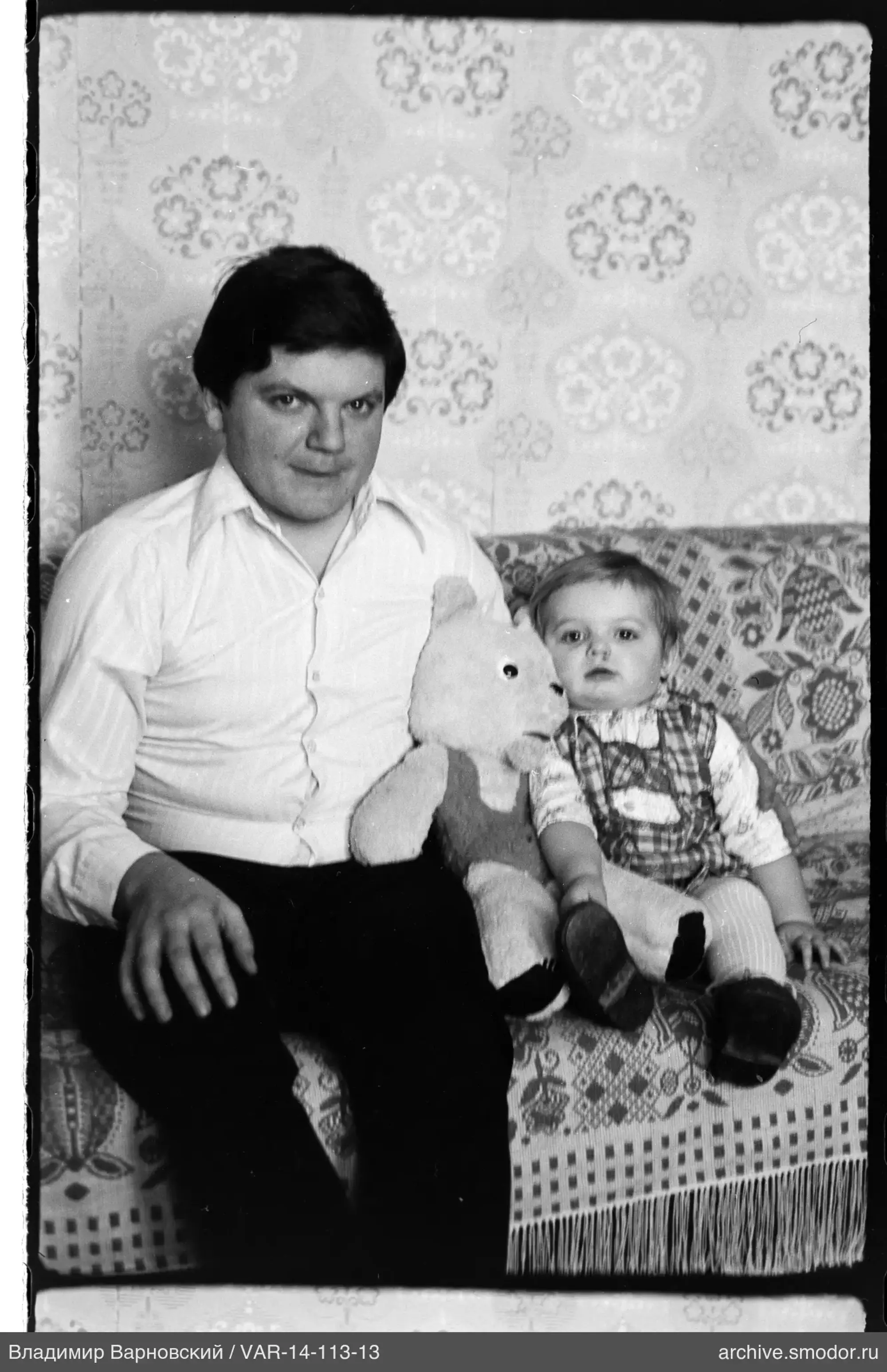 Мужчина и ребёнок с мягким медведем