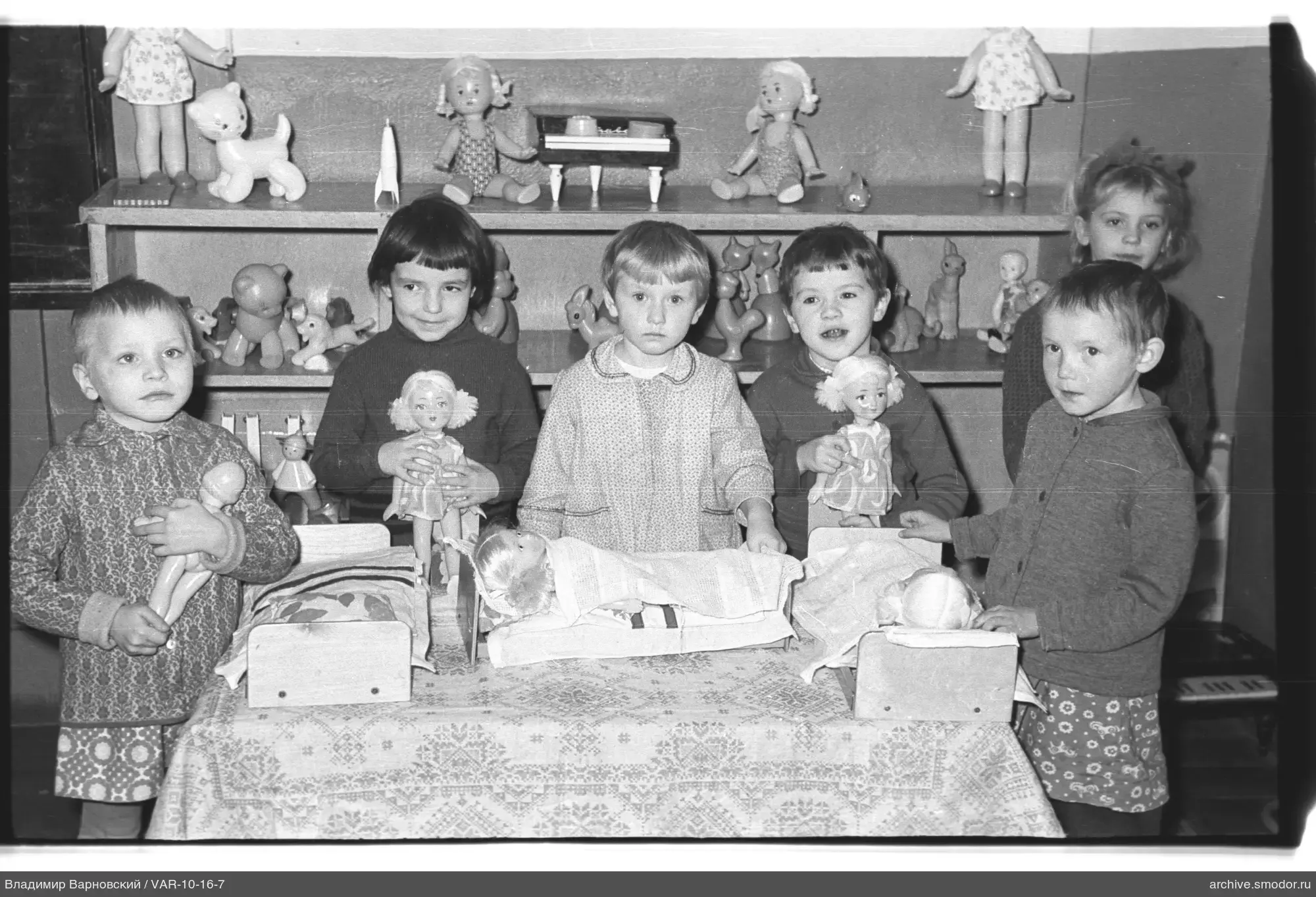 Group of children with dolls and toys