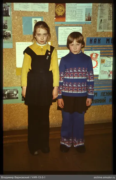 Two girls in front of an information board