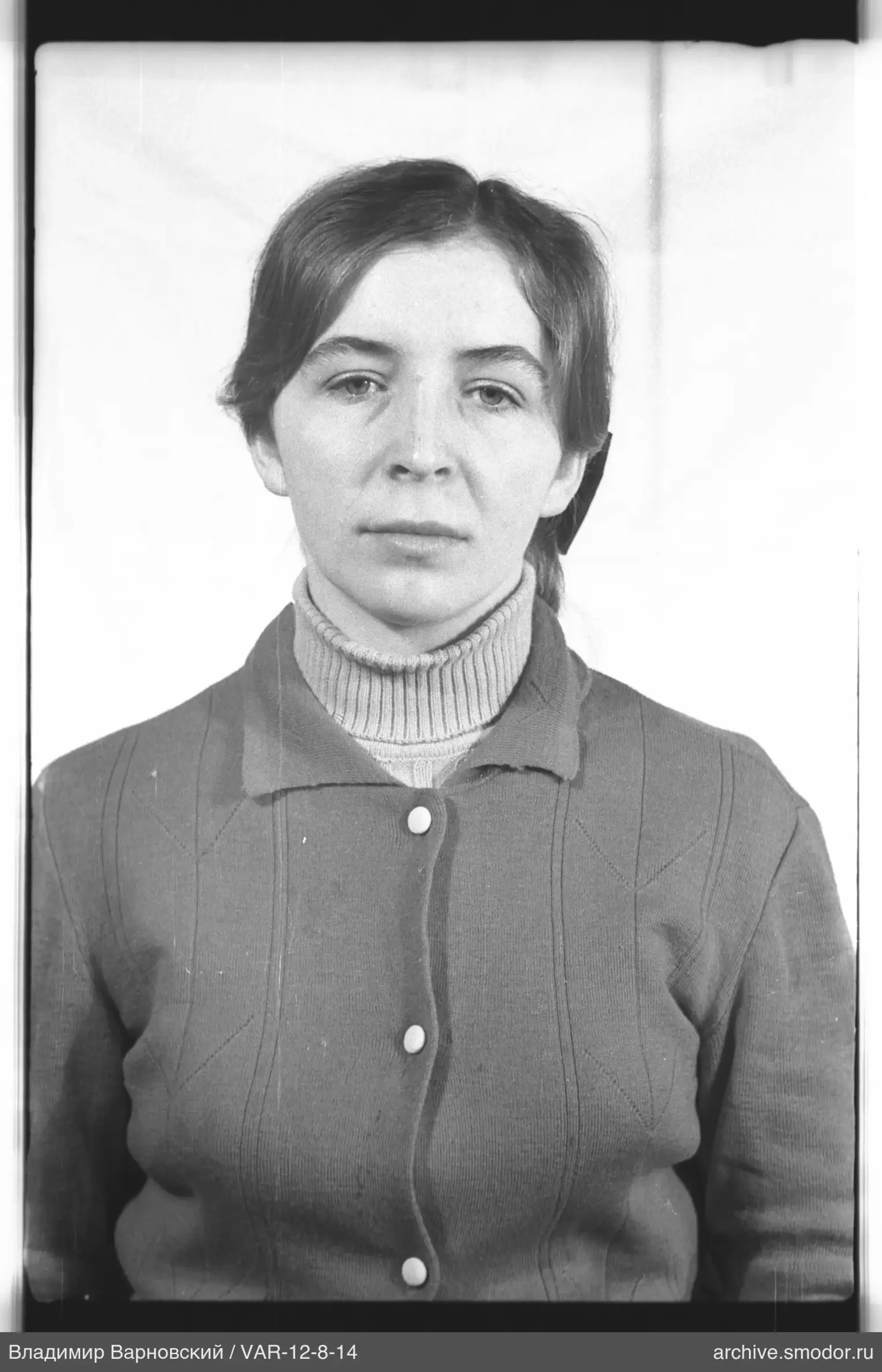 Porträt einer Frau in hellem Rollkragenpullover und dunkler Strickjacke