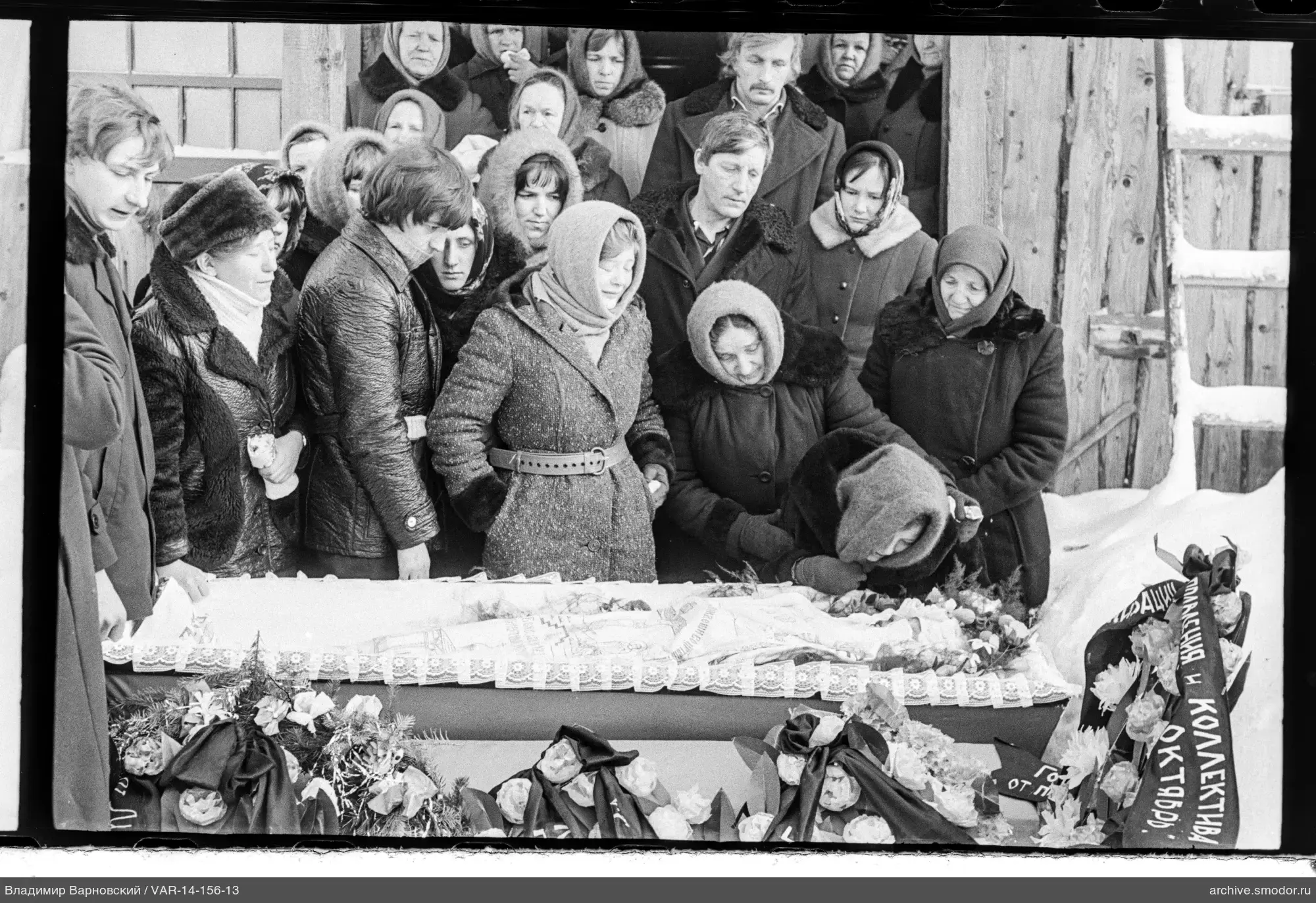 Group around coffin at funeral