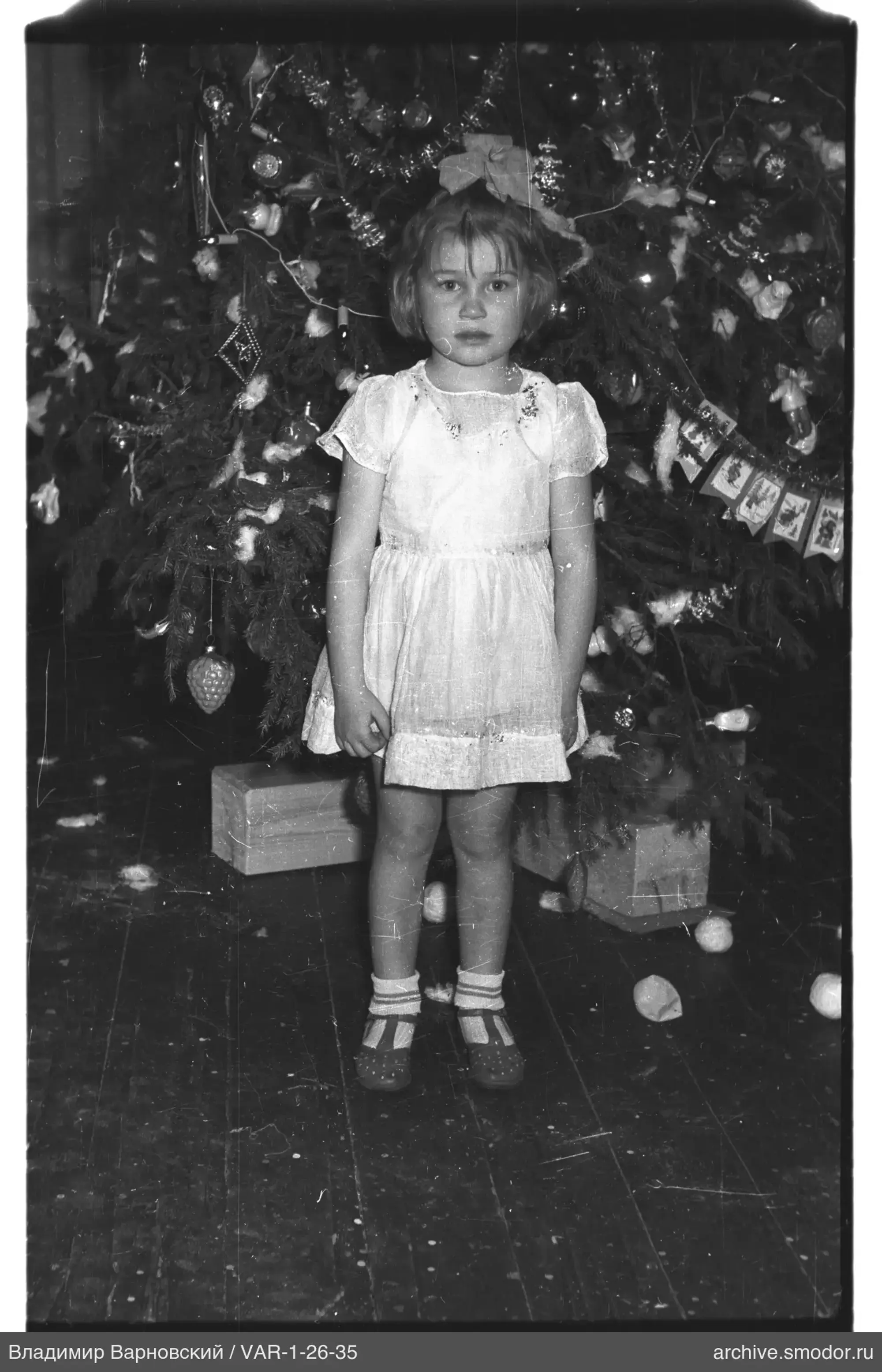 Girl in front of decorated Christmas tree