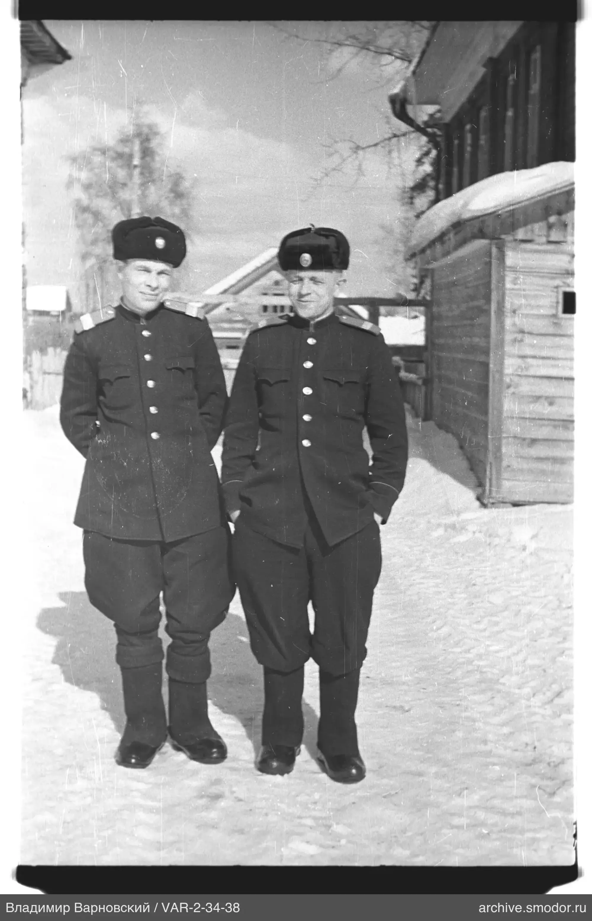 Two men in military uniforms in snow