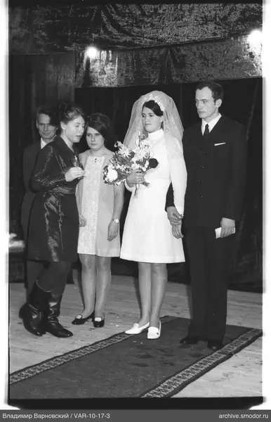 Group portrait with woman in white and men